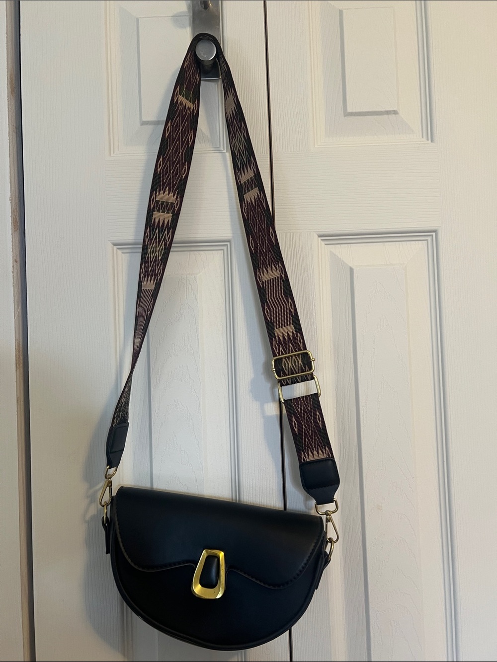 Black Crossbody Saddle Bag with Patterned Strap
